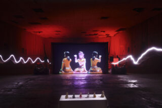 A photograph of a screen in the middle of an abandonned theatre in Phayao.