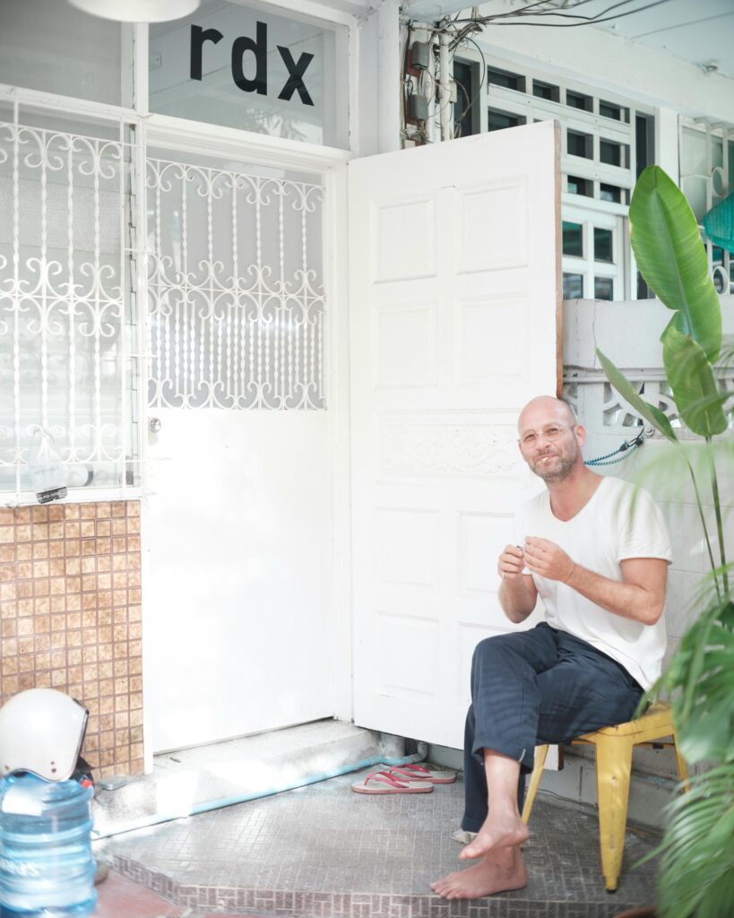 François Langella seated beside the open entrance to RDX Lab.