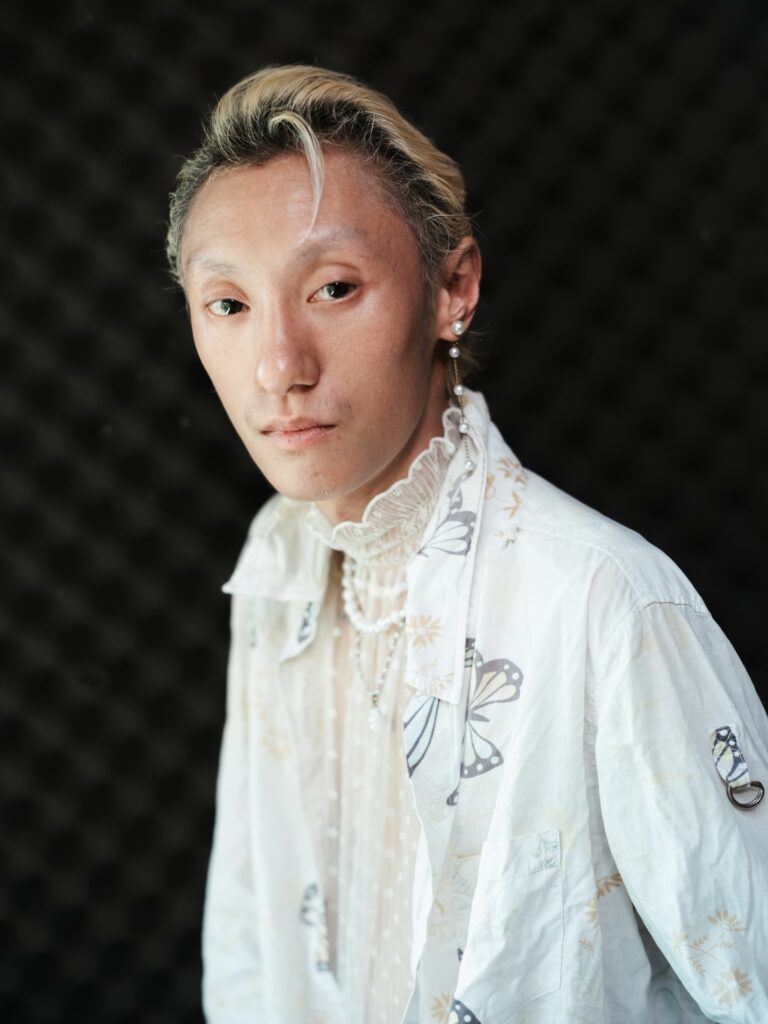 Close portrait of Qooqoo in a white embroidered jacket
