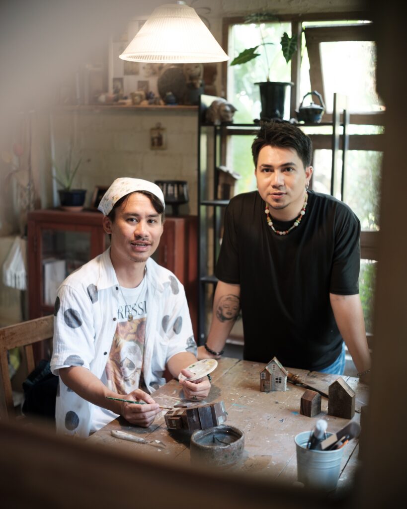 Tul and Em together at a wooden table in their home