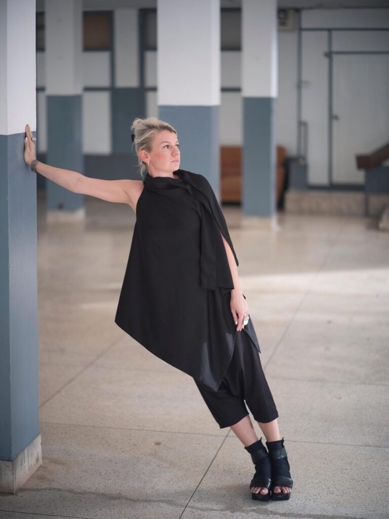Alexandra Polyakova leaning against a column in a Bangkok building.