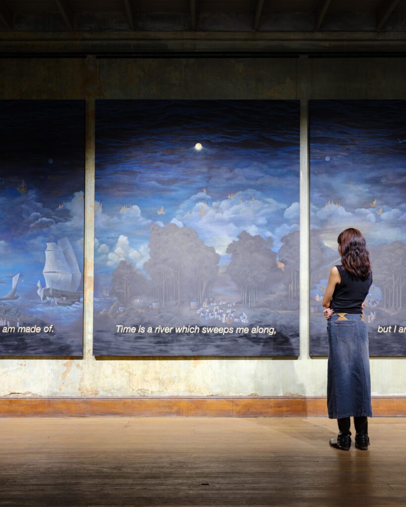 Issiree Shereen Sarntisart viewing a projected sky image inside a Bangkok building.