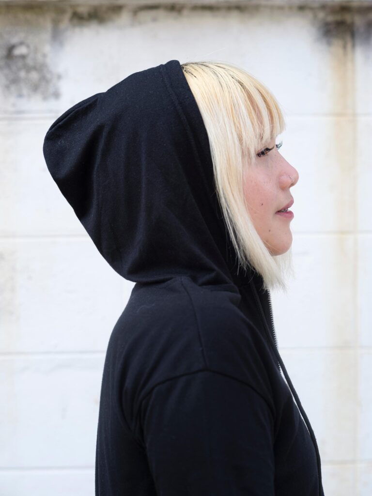 Side profile of Nadia Mania wearing a black hood in Chiang Mai.