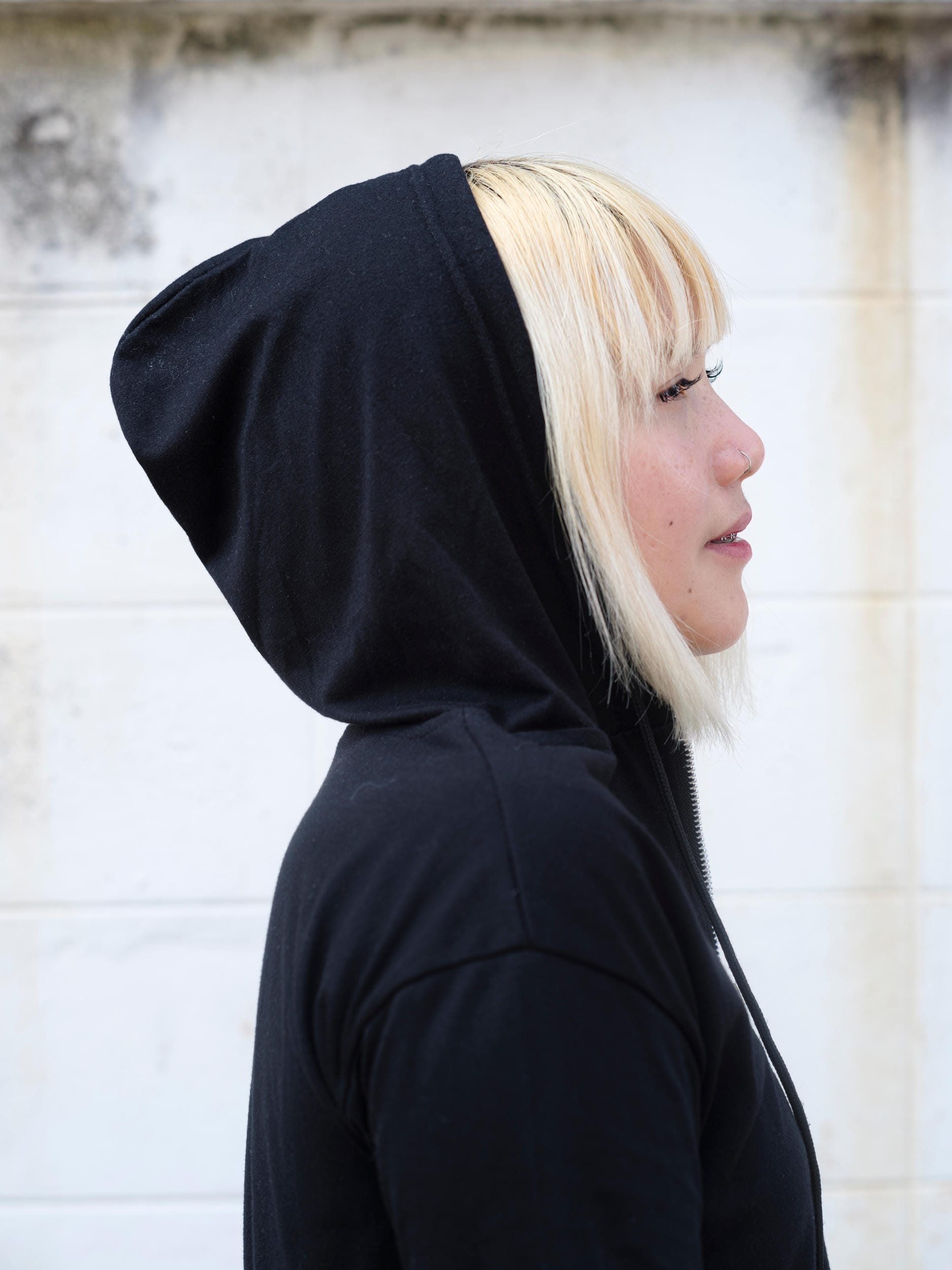 Side profile of Nadia Mania wearing a black hood in Chiang Mai.