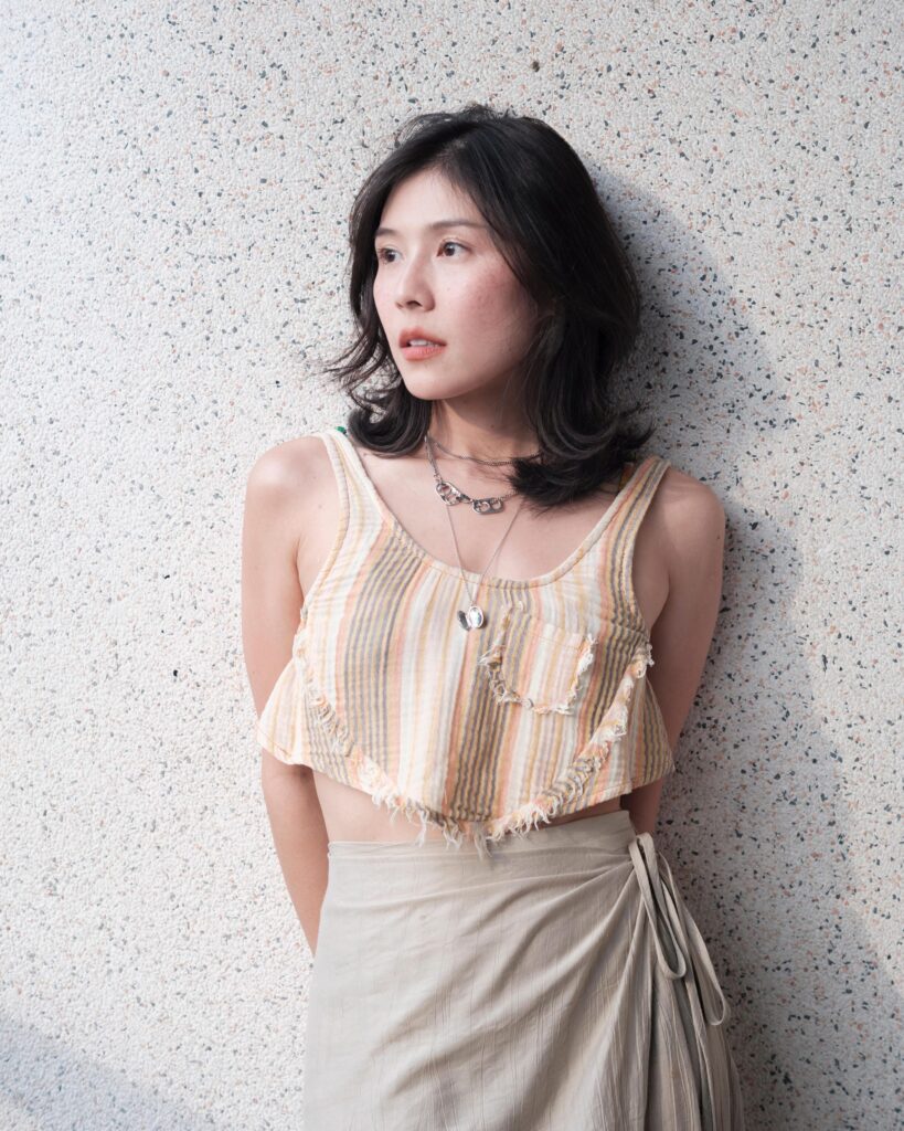 Pahparn Sirima standing against a speckled wall in Bangkok.