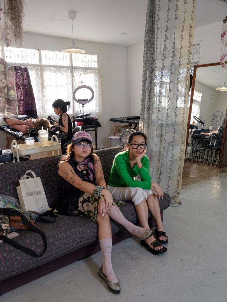 Two Q3Q Community members seated together inside their Bangkok studio.